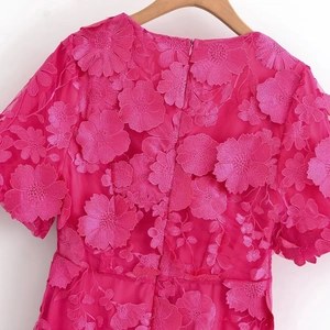 Détail de la broderie florale 3D et du tulle sur cette élégante robe rose fuchsia à col en V