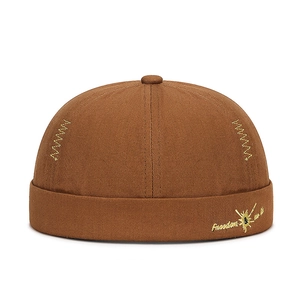 Brown docker hat with Freedom embroidery and yellow canvas details on white background