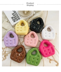 Flat lay of colorful mini PVC jelly bags with glossy finish and gold metal chain straps