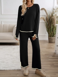 Chic black knitted two-piece lounge set with beige contrast stripes and wide-leg pants