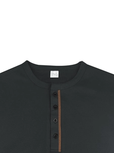 Close-up of waffle texture fabric and button placket on a men's polo shirt