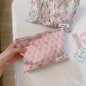 Pink heart and floral canvas makeup bags with zip closure shown from a top view