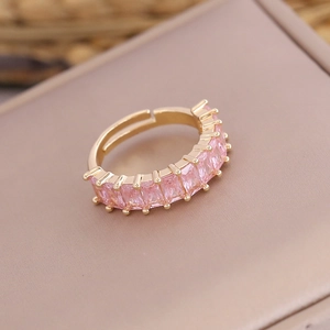 Detailed view of pink rectangular zirconia stones set in a gold-plated adjustable ring band