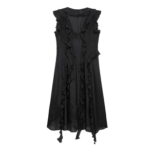 Detail view of the black V-neck dress featuring delicate ruffle layers and frayed edges