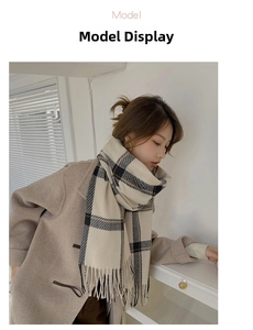 Detail of beige plaid cashmere-feel scarf featuring tassels styled with a light coat
