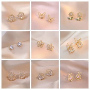 Collection of minimalist flower and heart stud earrings with cubic zirconia and gold finish