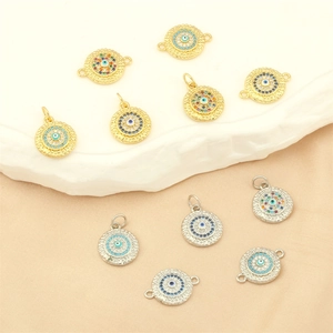 Gold and silver evil eye charms with colorful enamel and cubic zirconia on stone base