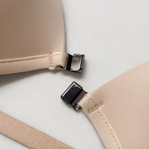 Front closure bra with triangle cups and metallic buckle on smooth nude fabric