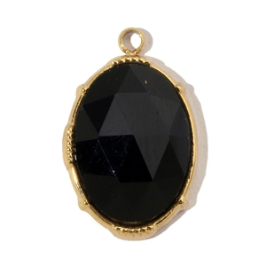 Macro view of oval faceted black natural stone pendant with gold titanium steel frame