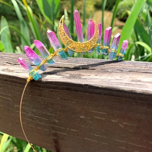 Macro detail of handmade bohemian crown featuring gradient crystals and a golden moon