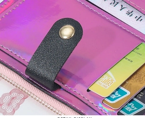 Macro detail of laser iridescent card wallet with pebble leather strap and metal zipper