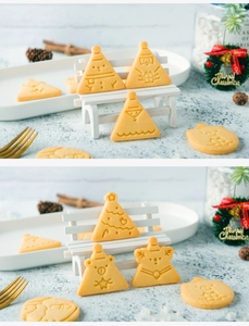Detailed view of Christmas cookies shaped like Santa and trees made with 3D cartoon molds