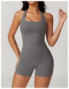 Detail view of high-waist seamless compression shorts and sports top in dark grey