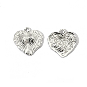 Macro detail of heart-shaped stainless steel pendant with letter Z and ripple texture