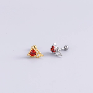 Close-up of gold and silver heart earrings with devil ear frames and screw backs