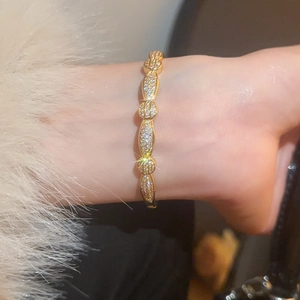 Macro detail of gold plated cubic zirconia bangle with linked circle design