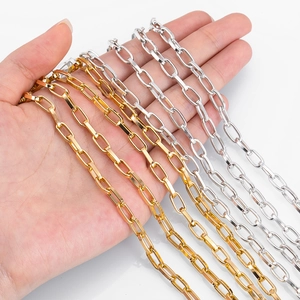 Golden and silver alloy paperclip chain necklace DIY materials held by hand for scale