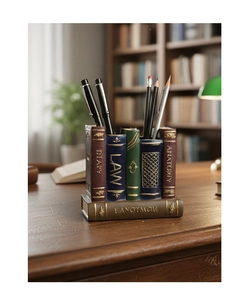 Close-up of vintage resin book-shaped pen holder with gold embossed spines for desk storage
