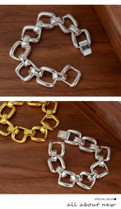 Detail of chunky square link bracelet in polished gold and silver metal finishes