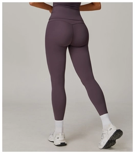 Macro detail of high-waisted yoga pants with butt-lifting stitching and plum matte fabric