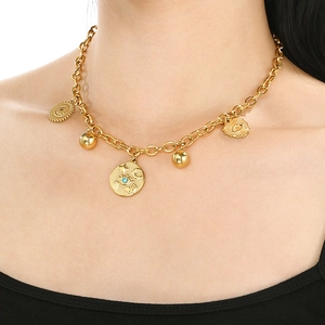 Close-up of gold stainless steel chain necklace with blue evil eye and round pendants