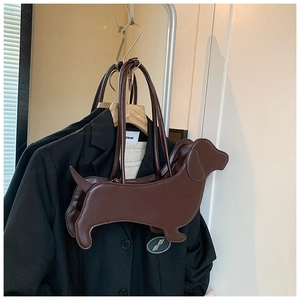 Detailed view of a dark brown dachshund-shaped shoulder bag hanging on a rack