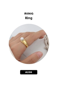 Close-up of 18k gold plated snake-style ring with a pearl inlay on a model hand