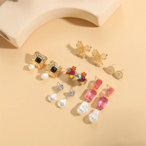 Baroque pearl and crystal earring set featuring gold floral and vintage stone designs