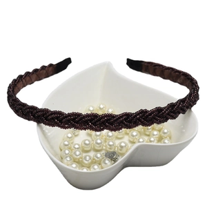 Elegant twisted braided headband in deep brown silk fabric with pearls on white display