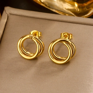 Macro detail of three-layered 18K gold plated stainless steel hoop earrings with glossy finish