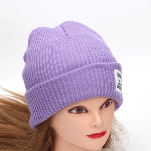 Classic purple ribbed knit beanie for winter featuring a white woven patch and cuff