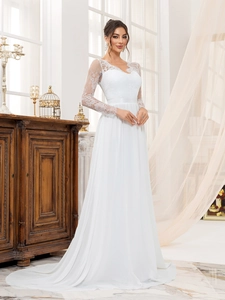 Elegant white lace wedding dress with long sleeves and flowy chiffon skirt