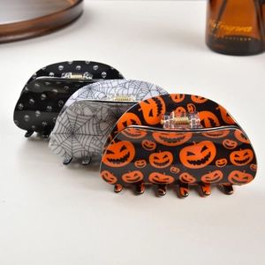 Halloween claw clip set featuring skull, spider web, and pumpkin patterns for hair styling
