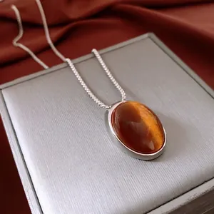 Retro resin oval brown pendant necklace with silver chain on velvet jewelry box