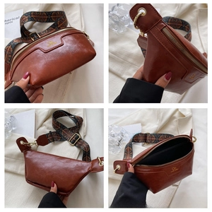 Detail of a brown half-moon crossbody bag with vintage texture and woven geometric strap