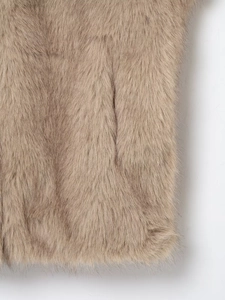 Detailed close-up of faux fur texture and seamless side pocket stitching on short vest