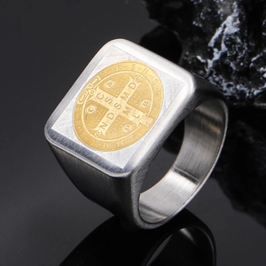 Detail of St. Benedict medal ring showing brushed steel finish and gold religious relief