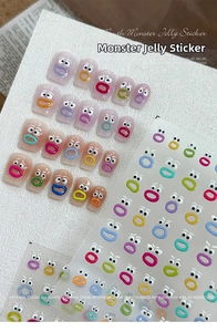 Close-up of 3D jelly nail stickers with cartoon big eyes and colorful mouth designs