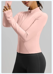 Slim-fit yoga jacket detail showing stand collar, zipper, and athletic thumbhole cuffs
