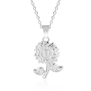 Macro view of silver sunflower pendant necklace with detailed petal and stem engraving