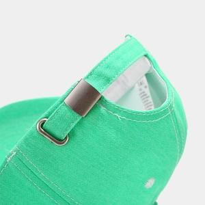 Detail of lime green baseball cap back with adjustable metal buckle and twill fabric