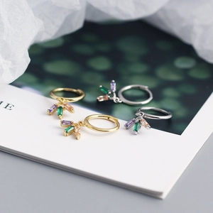 Detail of S925 silver earrings with colorful rectangular zircons in gold and silver finish