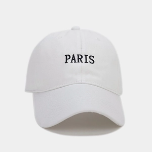 Close-up of black PARIS embroidery on a high-quality white cotton baseball cap