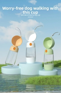 Portable pet water bottles in cream, white, and green on a bright outdoor display