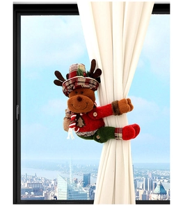 Detail of plush Christmas reindeer curtain tieback with plaid hat on beige curtains