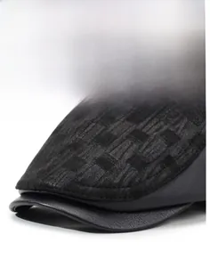 Detail of textured black fabric and faux leather brim on the men's baseball cap