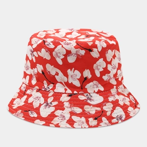 Detailed top view of red bucket hat with white cherry blossom print and clean stitching