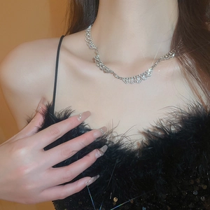 Elegant silver diamond-set wavy choker necklace shown on neck with sparkling starlight effect