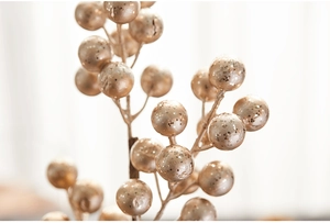 Detail of champagne gold sequined berry picks for elegant Christmas floral arrangements