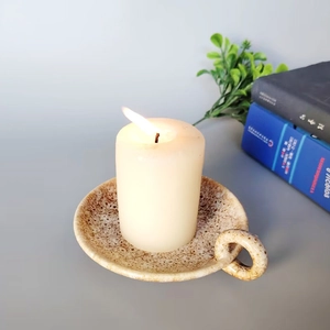 Modern ceramic candle holder with speckled brown glaze and white pillar candle set